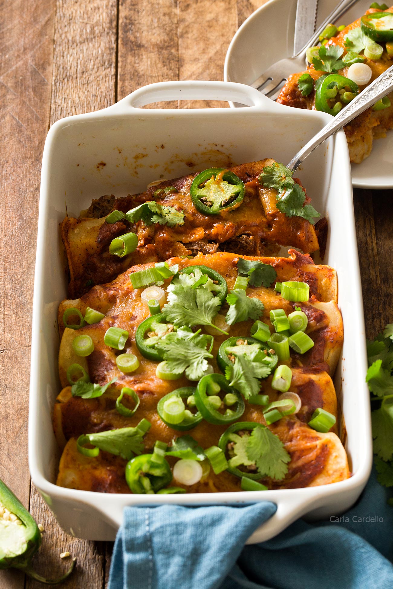 Beef Enchiladas in white casserole dish