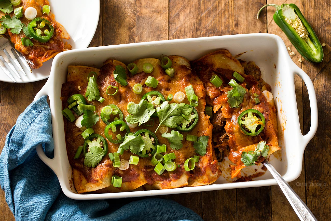 Beef Enchiladas in white casserole dish