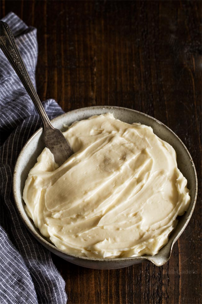 Small Batch Cream Cheese Frosting in a bowl with wooden spoon