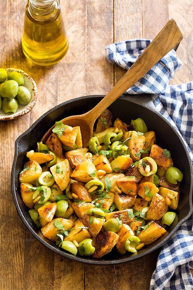 Small Batch Pan Fried Potatoes with Olives tossed with olive oil, parsley, and pine nuts.