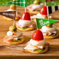 Antipasto Football Cracker Stacks with salami, turkey, ham, and mozzarella cheese