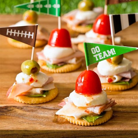 Antipasto Football Cracker Stacks with salami, turkey, ham, and mozzarella cheese