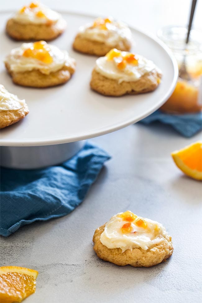 Soft Orange Cookies on white cake stand