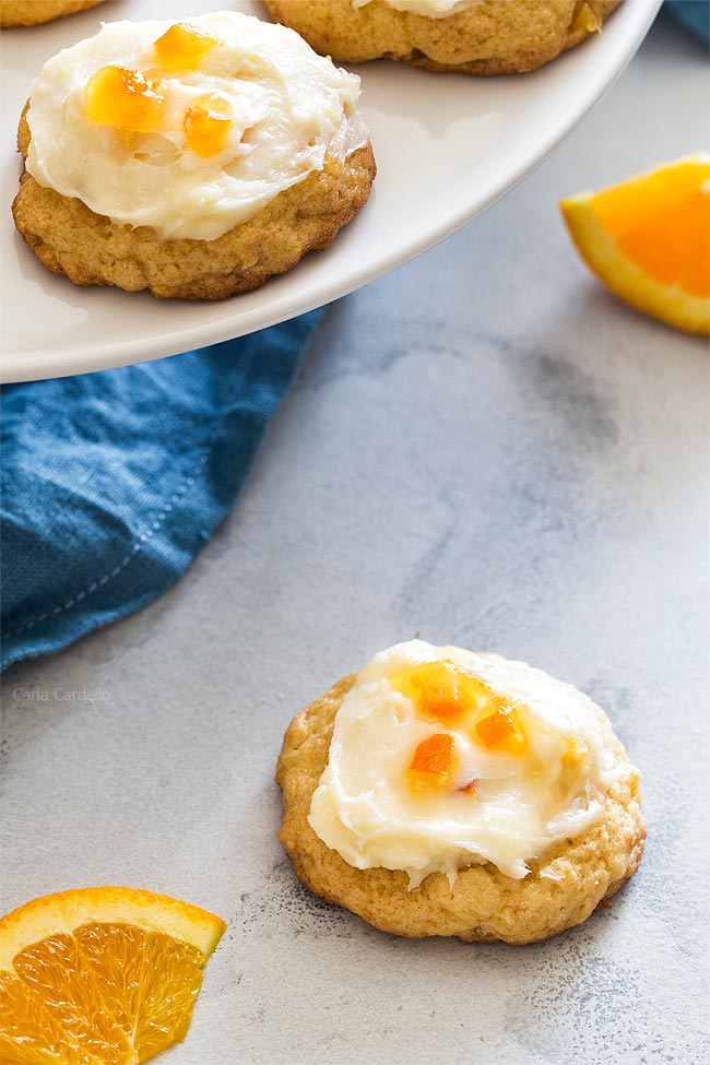 Orange Cookies on cake stand with one on table