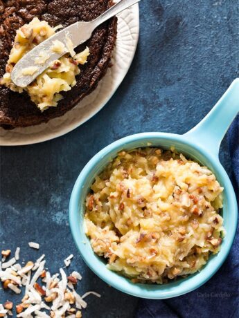 German Chocolate Cake Frosting in a blue bowl with cake