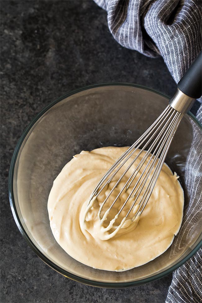 Peanut Butter Whipped Cream in glass bowl with whisk