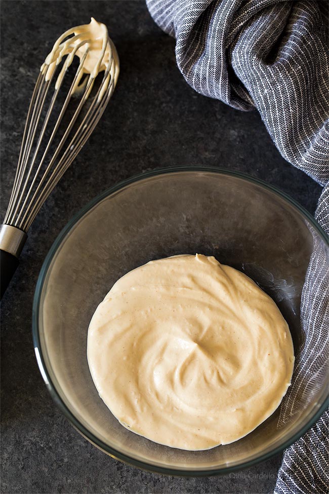 Peanut Butter Whipped Cream in glass bowl with whisk