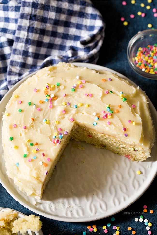 Birthday cake for two with slices cut out and served on white plates