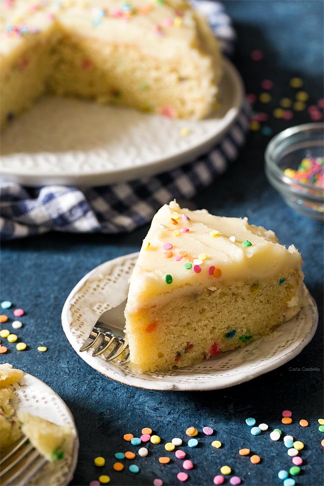 Slice of small birthday cake on white plate