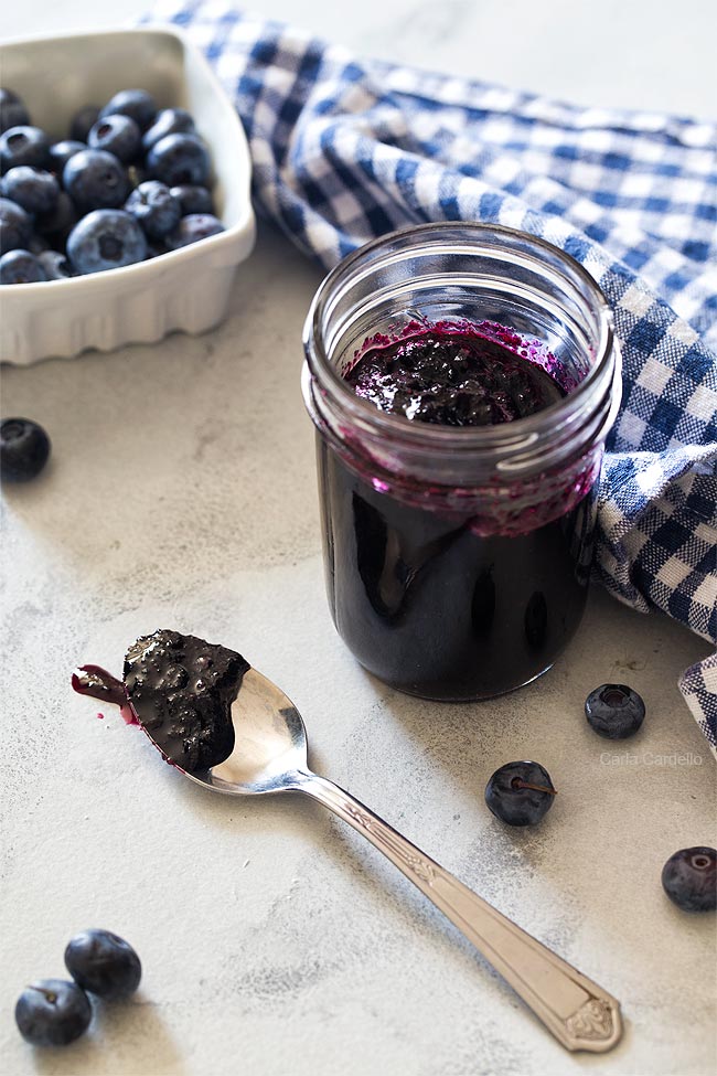 Jar of blueberry jam with spoon