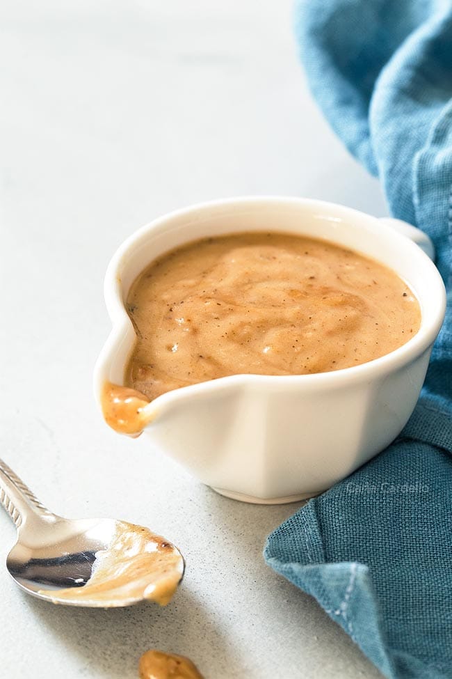 Gravy from drippings in white gravy bowl