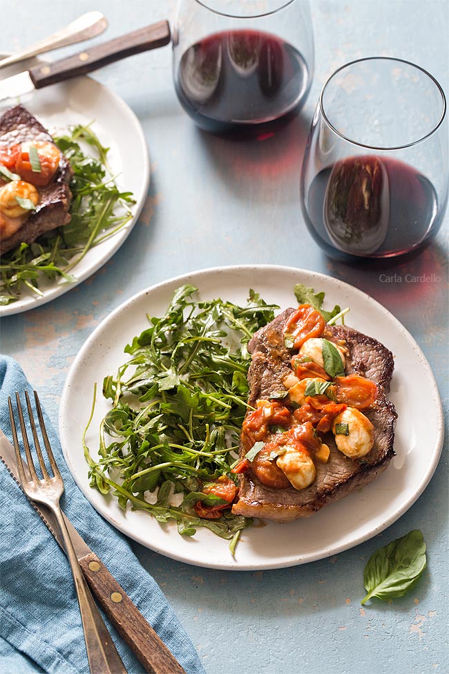 Steak dinner with salad and red wine