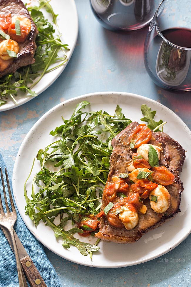 Steak dinner on plate with arugula salad