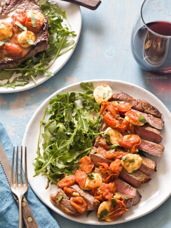 Sliced steak on plate with salad