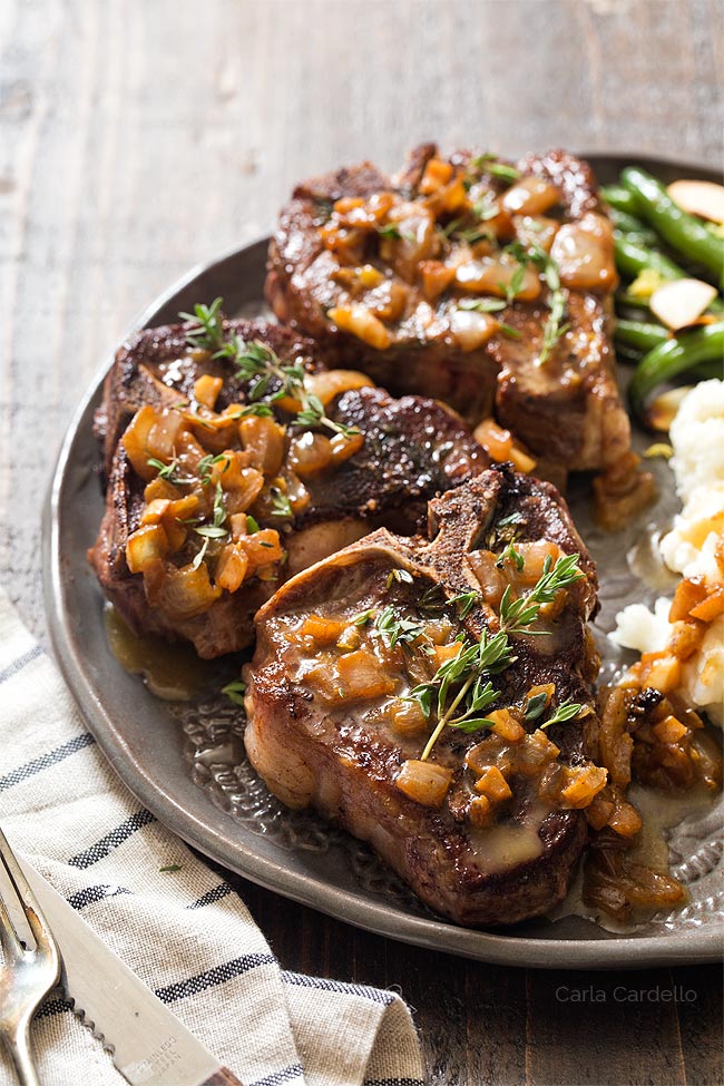 Lamb chops on plate with pan sauce