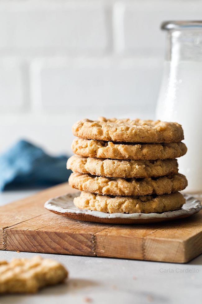 Peanut butter cookies on a plate on a cutting board