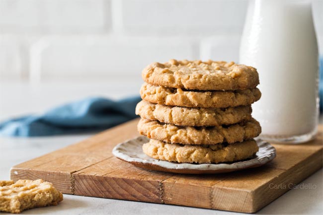 Peanut butter cookies on a plate on a cutting board