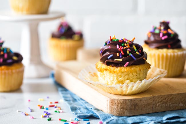 Small Batch Yellow Cupcakes with paper liner peeled back