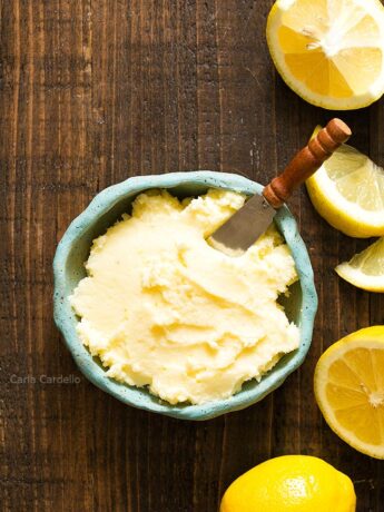 Blue bowl of Lemon Buttercream Frosting with lemon slices