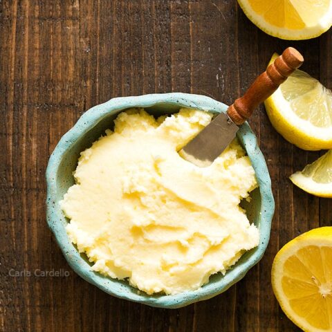 Blue bowl of Lemon Buttercream Frosting with lemon slices