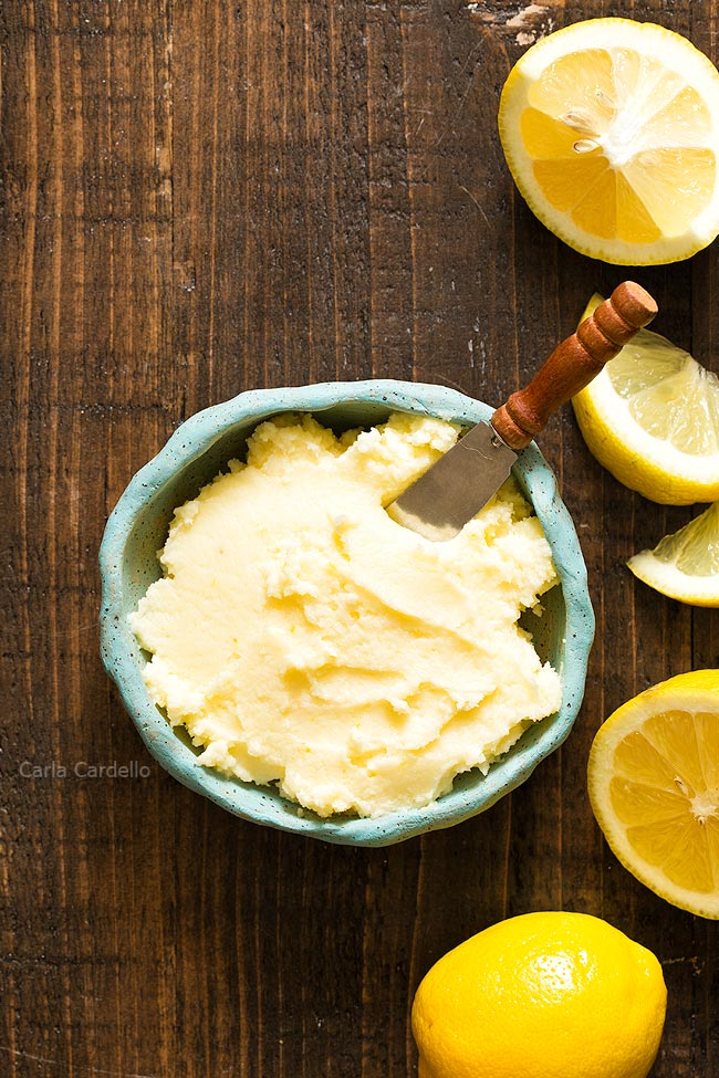 Blue bowl of Lemon Buttercream Frosting with lemon slices