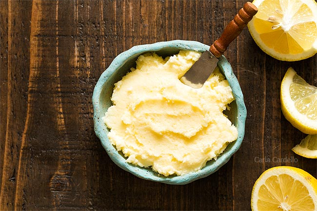 Blue bowl of Lemon Buttercream Frosting with lemon slices