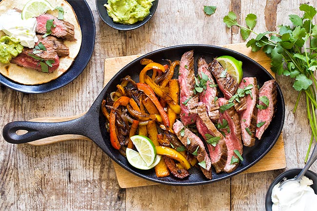 Steak and peppers served on cast iron pan