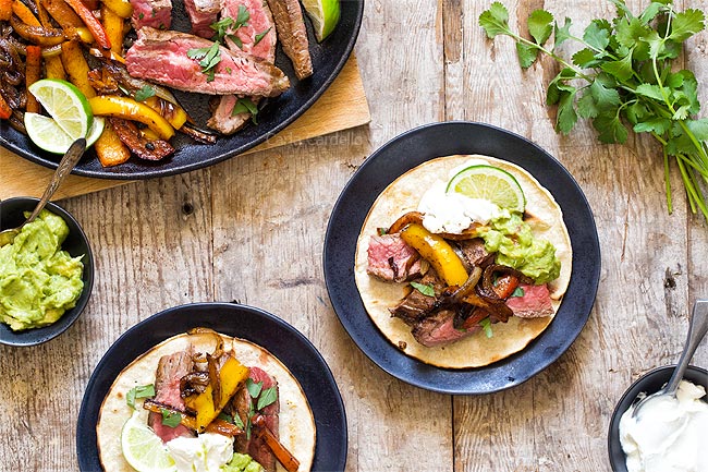 Steak fajitas served on tortillas