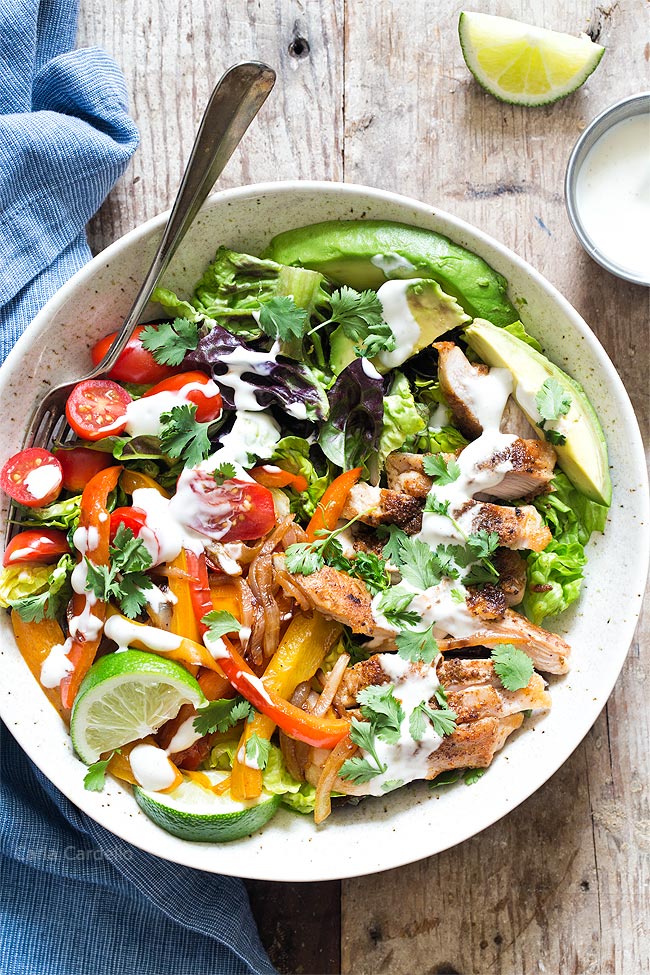 Chicken Fajita Salad with ranch drizzled on it