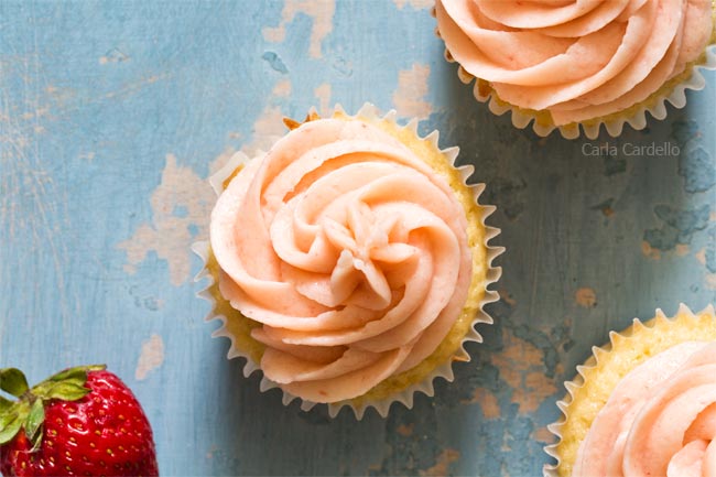 Strawberry buttercream piped on cupcake