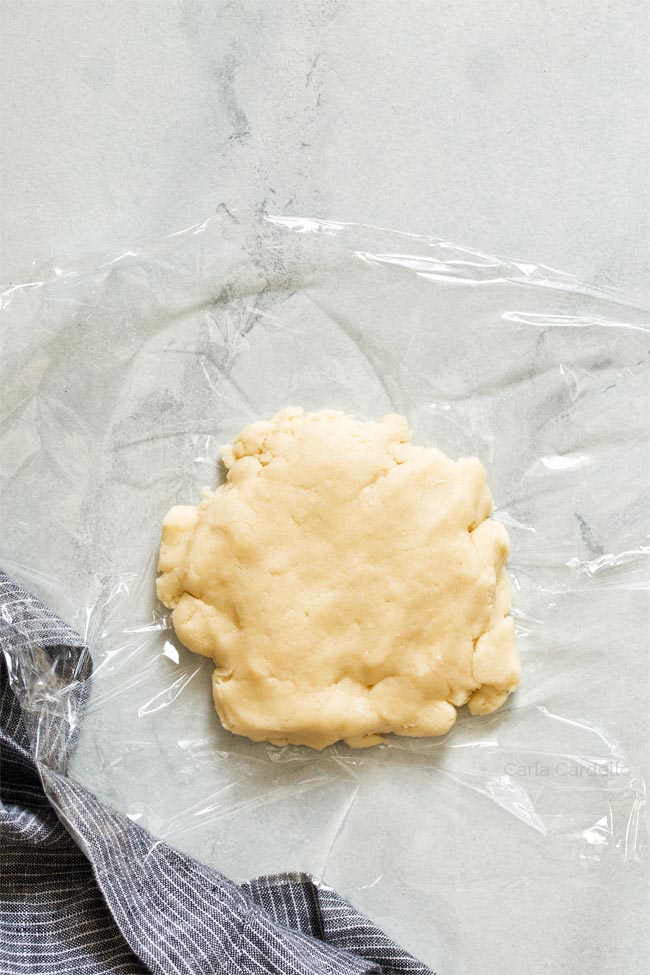 Pie dough on plastic wrap