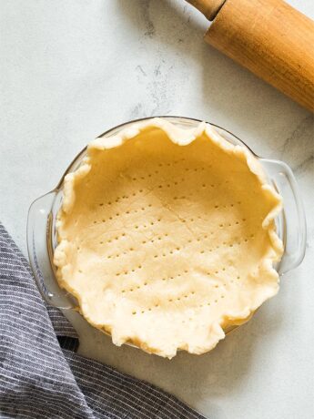 Unbaked pie dough in 6 inch pie plate