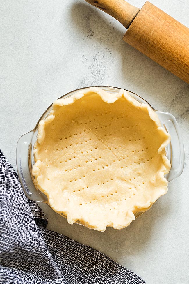 Unbaked pie dough in 6 inch pie plate