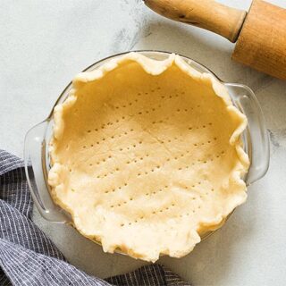 Unbaked pie dough in 6 inch pie plate