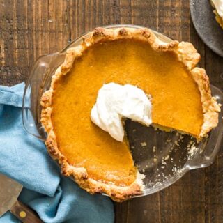 6 inch Pumpkin Pie in glass dish with slice missing