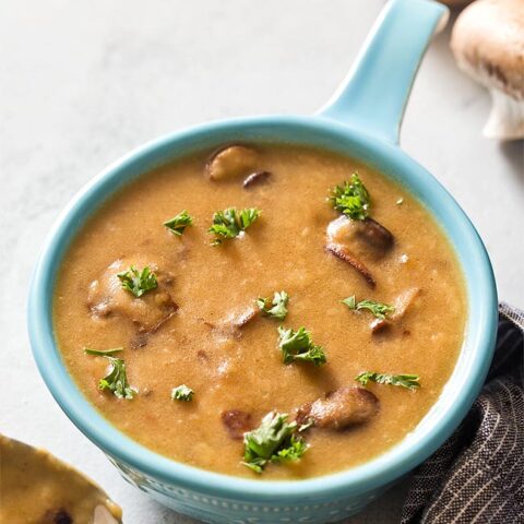 Blue bowl filled with brown mushroom gravy