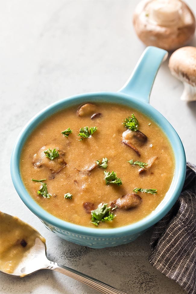 Blue bowl filled with brown mushroom gravy