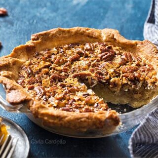 Pecan Pie with a slice missing in a glass pie plate