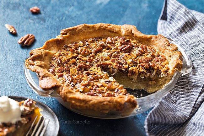 Pecan Pie with a slice missing in a glass pie plate