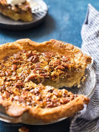 Pecan Pie with a slice missing in a glass pie plate