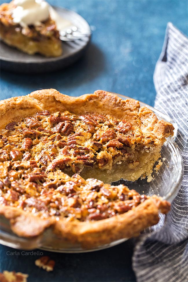 Pecan Pie with a slice missing in a glass pie plate