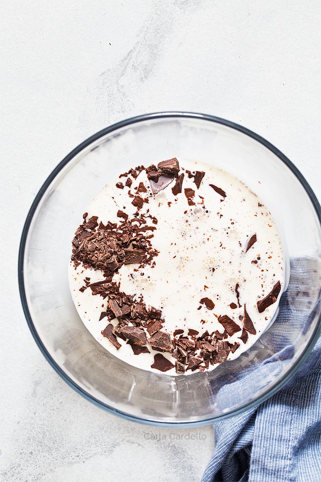 Cream added to chocolate in glass bowl