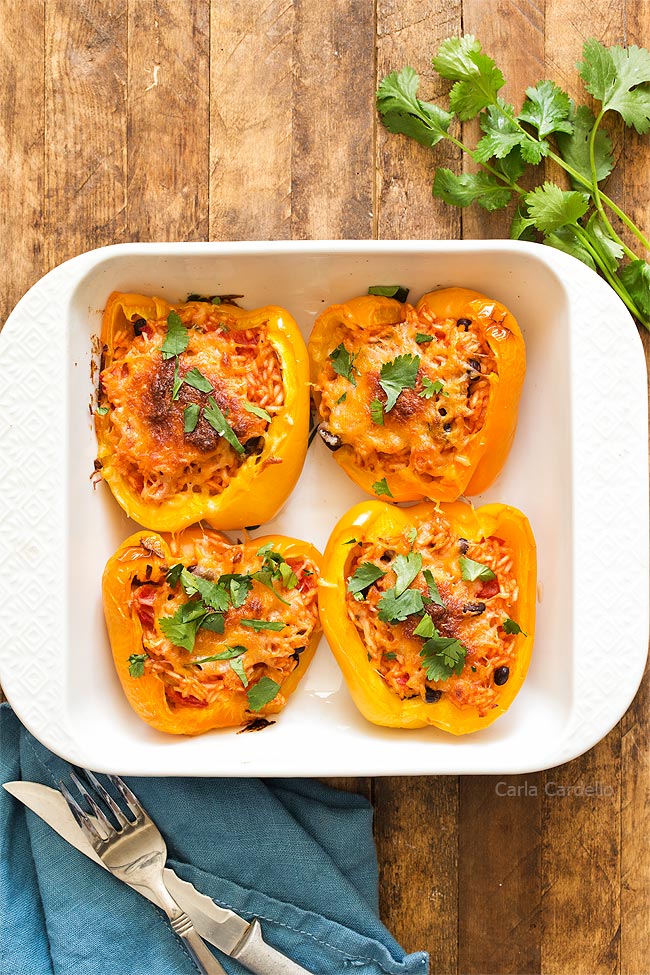 4 stuffed pepper halves in white baking dish