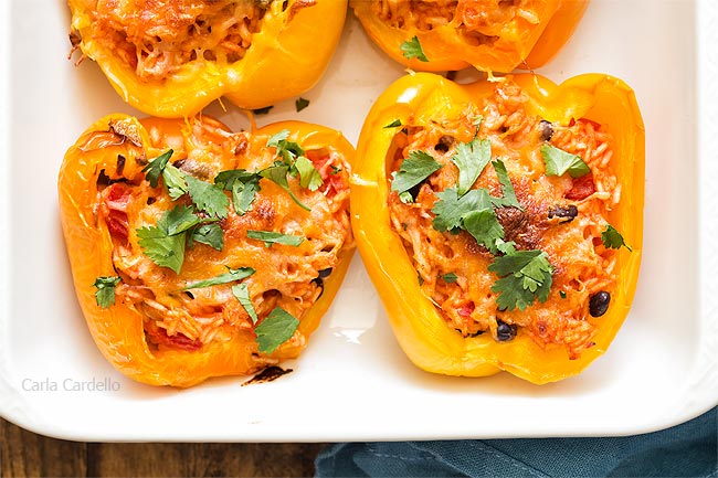 Close up of stuffed peppers in white baking dish