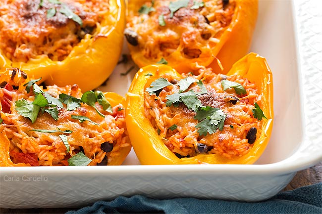 Close up of stuffed peppers in white baking dish