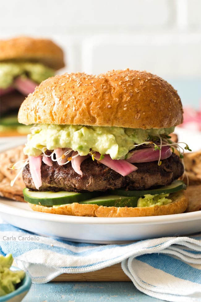 Close up of avocado burger on a white plate