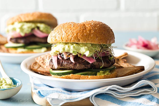 Avocado Burger on white plate with blue napkin