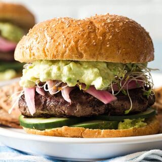 Close up of avocado burger on a white plate