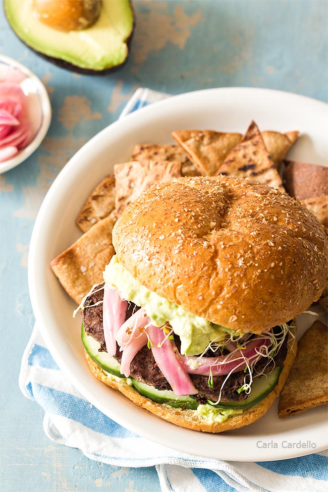 Angle of avocado burger on white plate