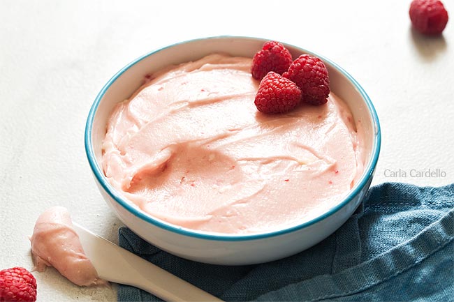 Raspberry cream cheese frosting in white bowl